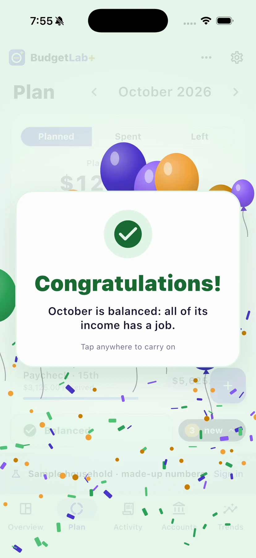 The Balanced celebration on iPhone: “Congratulations! October is balanced: all of its income has a job.” with balloons and confetti
